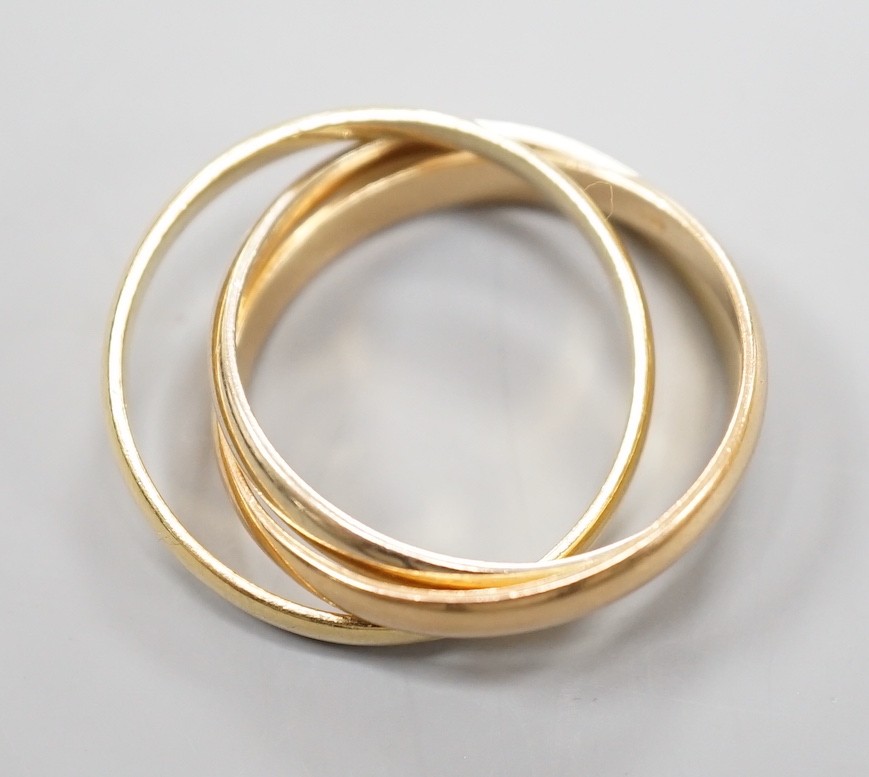 A modern Cartier three colour 750 yellow metal 'Russian' triple wedding ring, size U, 8.5 grams.